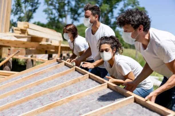 photo of volunteers building houses